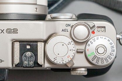 Top of the Contax G2 35mm film camera. Note the Exposure count LCD display beside the red dot and above the shutter speed dial. 