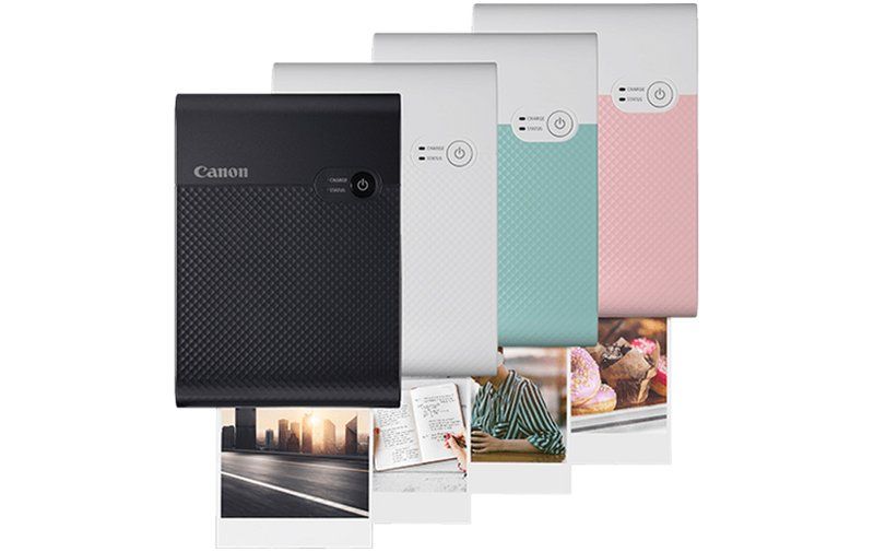 Canon Selphy Square QX10 Portable Printer in Black, White, Green, and Pink. 