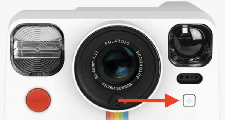 The self-timer button located on the front of the Polaroid Now Plus next to the camera lens and blew the viewfinder with a "+" icon