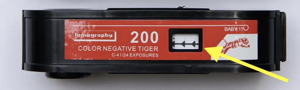 A film canister of Lomography Tiger 110 color film. Notice the frame counter window on the back of the film. The arrows mean the film has not been used and is ready to be loaded into the camera.