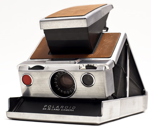 Polaroid SX-70. Has not build in self timer but has an adapter.